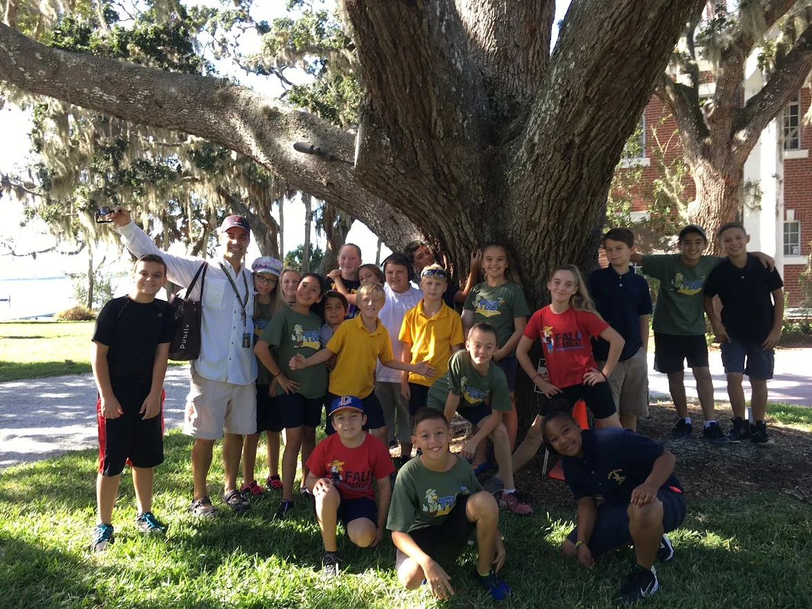 A class group gathered under a live oak during a Sarasota field trip