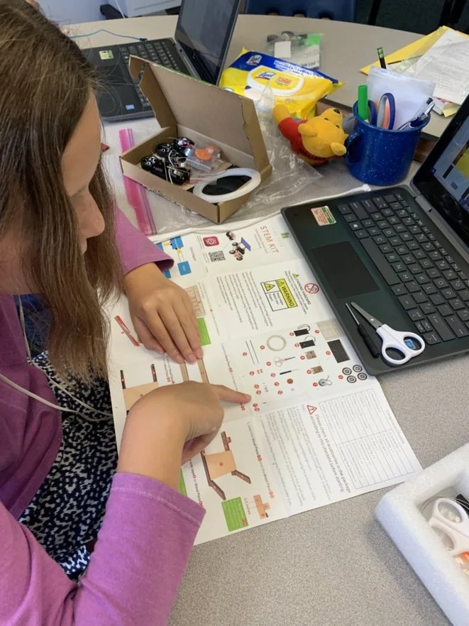 A student following the build instructions for a STEM engineering project